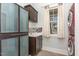 Convenient laundry room features a modern washer and dryer, cabinets, and a sink at 511 Hillsborough St # 103, Chapel Hill, NC 27514