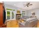 Bright living room featuring a cozy fireplace, wood floors, and double french doors leading to porch at 511 Hillsborough St # 103, Chapel Hill, NC 27514