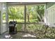 Enjoy outdoor dining on this screened-in porch with a grill and comfortable seating at 511 Hillsborough St # 103, Chapel Hill, NC 27514