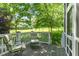 Charming porch featuring comfortable seating with a lovely view of the landscaped yard at 511 Hillsborough St # 103, Chapel Hill, NC 27514