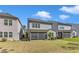 A well-maintained backyard featuring a screened porch and grassy lawn, perfect for outdoor enjoyment at 512 Flip Trl, Cary, NC 27513