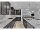 Spacious kitchen featuring dark cabinets, granite countertops, subway tile backsplash, and stainless steel appliances at 512 Flip Trl, Cary, NC 27513