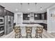 Modern kitchen with dark cabinets, a large island, granite countertops, and stainless steel appliances at 512 Flip Trl, Cary, NC 27513