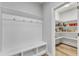 Well-organized mud room with a bench, storage shelves, and access to a pantry at 512 Flip Trl, Cary, NC 27513