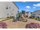 Community playground area featuring a slide and climbing structure with wood chip ground cover at 512 Flip Trl, Cary, NC 27513
