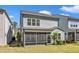 Rear exterior featuring a private screened-in porch and well-manicured lawn, creating an inviting outdoor space at 512 Flip Trl, Cary, NC 27513