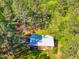 Aerial view of the house featuring a white roof surrounded by lush trees at 5204 William And Mary, Raleigh, NC 27616