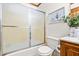 Bathroom featuring a glass shower, toilet, and a vanity with decorative accents and storage at 5204 William And Mary, Raleigh, NC 27616