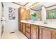 Well-lit bathroom featuring a vanity with ample storage, a large mirror, and decorative floral accents at 5204 William And Mary, Raleigh, NC 27616