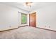 Bedroom featuring neutral carpet, a window with natural light, and a closet with wooden doors at 5204 William And Mary, Raleigh, NC 27616