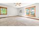Spacious bedroom with neutral carpet, two windows with natural light, and a ceiling fan at 5204 William And Mary, Raleigh, NC 27616