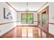 Sunlit dining room with hardwood floors, chandelier, and French doors leading to a patio at 5204 William And Mary, Raleigh, NC 27616