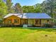 Attractive home featuring a mix of stone and wood siding, complemented by a green lawn at 5204 William And Mary, Raleigh, NC 27616