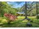 Quaint home with stone accents and a well-manicured lawn, surrounded by mature trees and azaleas at 5204 William And Mary, Raleigh, NC 27616