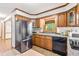 Functional kitchen featuring wood cabinets, stainless steel refrigerator, and updated appliances at 5204 William And Mary, Raleigh, NC 27616