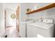 Laundry room with washer and dryer, shelving for storage, and natural light from the window at 5204 William And Mary, Raleigh, NC 27616
