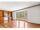 Spacious living room with hardwood floors, built-in shelves, and a large bay window with wooded views at 5204 William And Mary, Raleigh, NC 27616