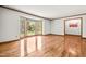 Bright living room featuring hardwood floors, a large bay window, and natural light at 5204 William And Mary, Raleigh, NC 27616