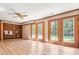 Basement living room with shelving, laminated flooring, and exterior access at 5204 William And Mary, Raleigh, NC 27616