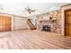 Finished basement with a stone fireplace, laminate flooring, and a walkout to the exterior at 5204 William And Mary, Raleigh, NC 27616