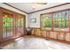 Cozy sunroom with wood-paneled walls, tile flooring, and bright windows offering outdoor views at 5204 William And Mary, Raleigh, NC 27616