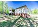 Back of house with covered porch and landscaped yard, creating a relaxing outdoor environment at 524 Auguston Ct, Sanford, NC 27330