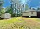 Large backyard with a shed and mature trees provides ample space for outdoor activities and storage at 524 Auguston Ct, Sanford, NC 27330