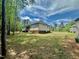 Spacious backyard features mature trees and well-maintained lawn, creating a serene outdoor space at 524 Auguston Ct, Sanford, NC 27330