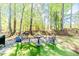 Charming backyard patio with a table and chairs, set against a backdrop of lush green trees at 524 Auguston Ct, Sanford, NC 27330