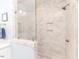 Bathroom shower with marble tiles, glass door, a shower head and a corner caddy at 524 Auguston Ct, Sanford, NC 27330