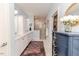 Bright bathroom featuring a double vanity, marble floors, a shower and a rustic blue dresser at 524 Auguston Ct, Sanford, NC 27330