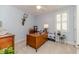 Bright bedroom used as an office, features a large desk, a ceiling fan, and a window with white shutters at 524 Auguston Ct, Sanford, NC 27330