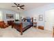 Bedroom with ceiling fan, shutters, and a warm decor with wooden furniture at 524 Auguston Ct, Sanford, NC 27330