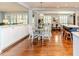 Bright open dining area with hardwood floors and white cabinets and a view of the kitchen at 524 Auguston Ct, Sanford, NC 27330