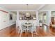 Dining area featuring a glass table, white chairs, and wood floors at 524 Auguston Ct, Sanford, NC 27330