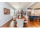 Dining room featuring hardwood floors, crystal chandelier, and view of stainless appliances at 524 Auguston Ct, Sanford, NC 27330