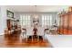 Dining room with hardwood floors, shuttered windows, crystal chandelier, and wooden cabinet at 524 Auguston Ct, Sanford, NC 27330