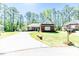 Charming home with well-maintained lawn, mature trees, and spacious driveway in a peaceful setting at 524 Auguston Ct, Sanford, NC 27330