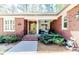 Welcoming front porch with seating area, brick facade, and manicured landscaping enhances the home's curb appeal at 524 Auguston Ct, Sanford, NC 27330