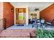 Inviting front porch with brick columns, rocking chairs, and decorative 
