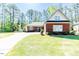 Charming brick home with well-manicured lawn and long driveway on a sunny day at 524 Auguston Ct, Sanford, NC 27330