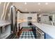 Bright kitchen features stainless steel appliances, white cabinets, and a large island with sink at 524 Auguston Ct, Sanford, NC 27330