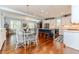Open concept kitchen with island, stainless appliances, and a breakfast nook with wood floors at 524 Auguston Ct, Sanford, NC 27330