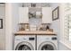 Bright laundry room with white cabinetry, butcher block countertop, and modern washer and dryer units at 524 Auguston Ct, Sanford, NC 27330