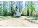 Backyard with a shed surrounded by trees, providing ample space for outdoor activities and storage at 524 Auguston Ct, Sanford, NC 27330