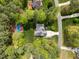 Aerial view of property, highlighting mature trees, pool, driveway, and well-maintained landscaping at 524 Birdsong Ln, Hurdle Mills, NC 27541