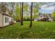 Expansive backyard showcasing a detached outbuilding, pool area, and mature trees at 524 Birdsong Ln, Hurdle Mills, NC 27541