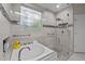 Luxurious bathroom featuring a soaking tub, glass shower, and stylish tile work at 524 Birdsong Ln, Hurdle Mills, NC 27541