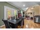 Bright dining area with access to the deck, leading to an open floor plan at 524 Birdsong Ln, Hurdle Mills, NC 27541