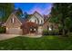 Charming brick and vinyl home with a lush green lawn and mature landscaping at 524 Birdsong Ln, Hurdle Mills, NC 27541